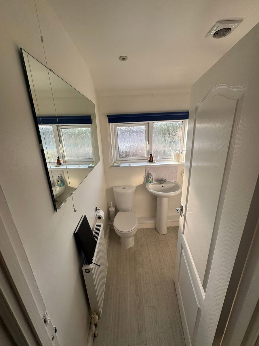 Bathroom with black-framed shower screen fitted in Exeter